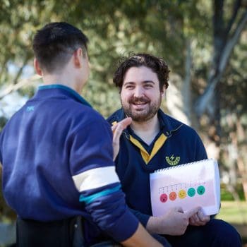 Therapist supporting communication and emotional expression using visual supports